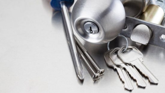 Bored locks preassembled with ANSI/BHMA A156.2-2017 guidance with a screwdriver and some keys