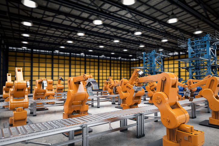 Yellow robot arms following ANSI B11.20-2017 to function independently in factory conveyor.