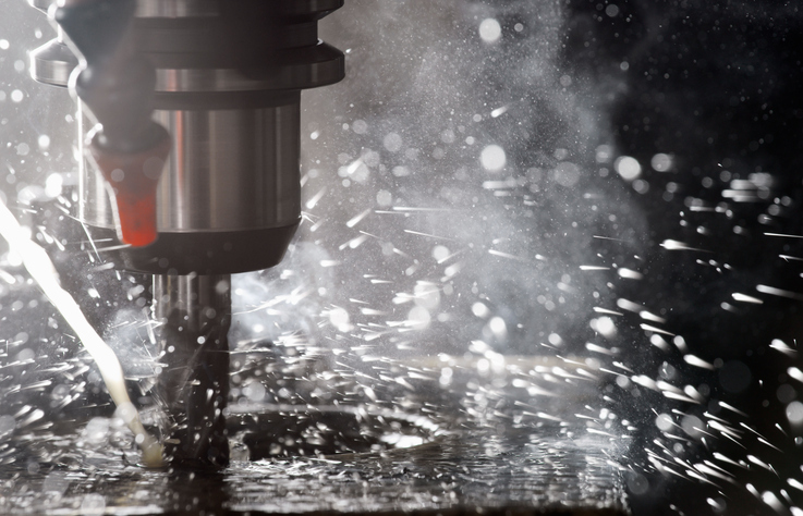 Factory drill with splashing flecks operating as one of the ISO Type ABC machinery according to ANSI B11.