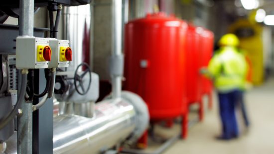 Large red canisters used for industrial heating oil under ASTM D396