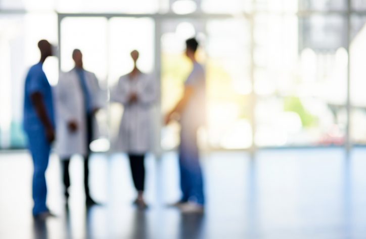 A group of hazy doctor talking about using ANSI/AAMI/ISO 11737-1 to sterilize microorganisms