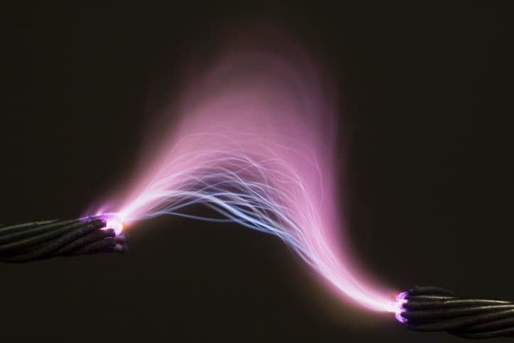 Bright purple electric arc illuminating the dark specified in ASTM F1506-20.