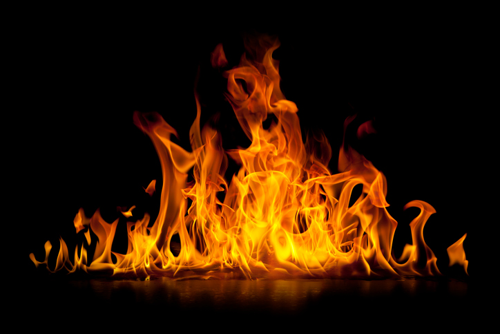 Bright fire over black background for which only ASTM F1506-20 FR and AR rated clothing can protect against.