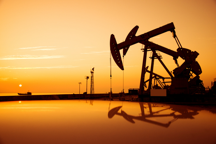 Oil pump jack the follows ASTM D4052 with the sunset in the background