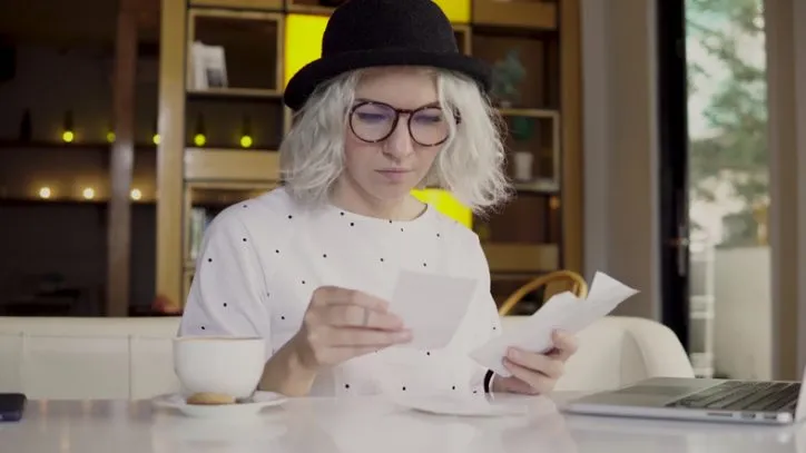 Hipster young woman checking her check and converting to Image Replacement Document (IRD).
