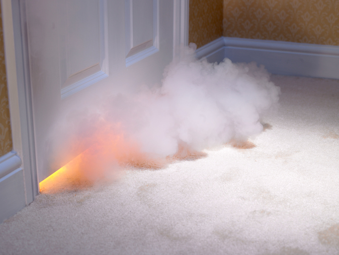 Smoke coming out from underneath a door