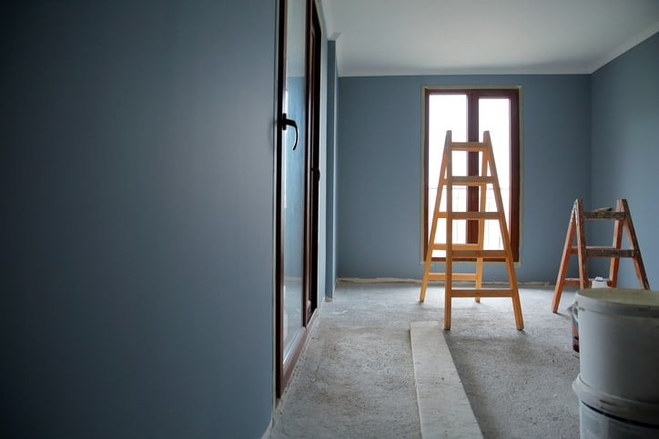 A couple of ANSI ASC A14.1-2017 wood ladders help a family safely paint their home.