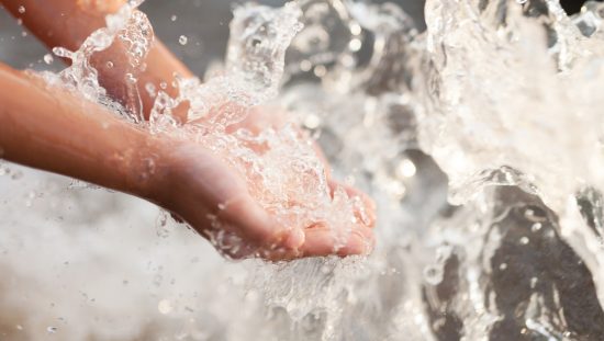 Water splashing on hands represents the dual check backflow that is set by ASSE Standard 1024-2017