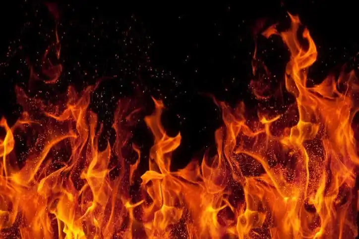 Flames that emerge brightly on black background when not using ASTM E2174-20 for inspecting firestops.