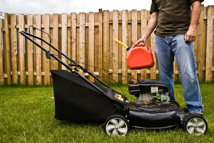 Adding some gasoline to a ANSI/OPEI B71.10-2018 off-road ground-supported push lawnmower.