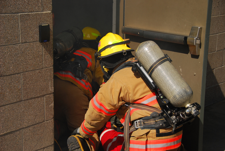 Two firefighters entering a building
