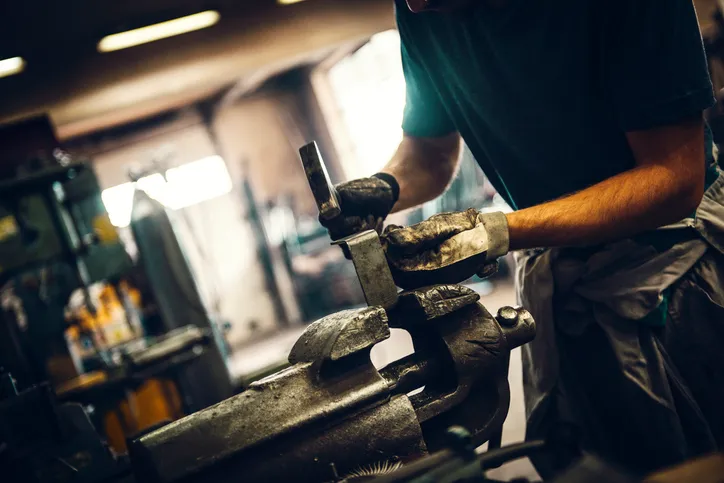 Striking a dirty hammer and wearing ANSI/ISEA 138-2019 impact-resistant gloves