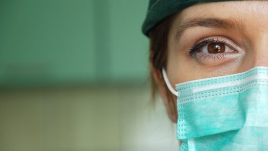 Woman wearing a medical face mask designed to ASTM F2100-20.