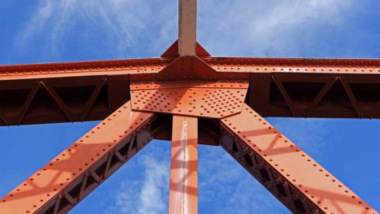 Red beams support bridge and are covered with ISO 12944 protective steel paint.