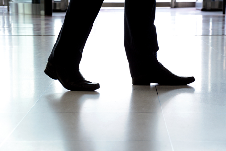 Businessman walking on NSFI safe floor.