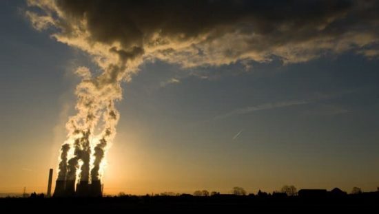 Power plant emits smoke and in need of ISO 14064 standards for quantifying greenhouse gas emissions.