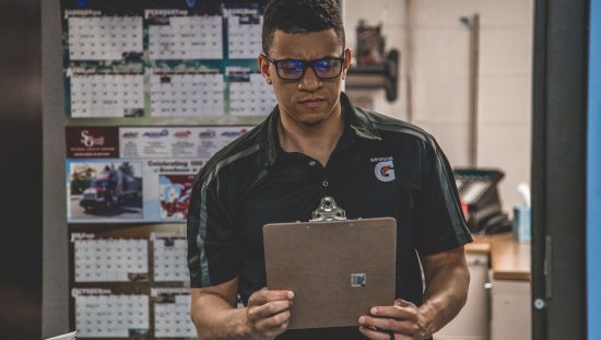Man checking out his warehouse safety checklist to make sure his workplace is safe from hazards.