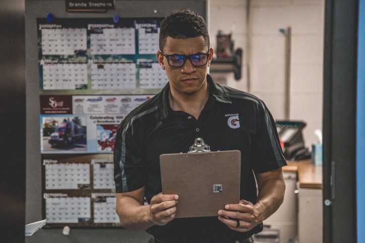 Man checking out his warehouse safety checklist to make sure his workplace is safe from hazards.