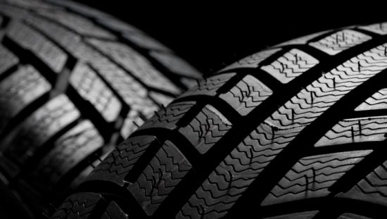 Two car tires with tread and colored black due to carbon black.