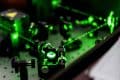 Green lasers emitted on circuit board in compliance with ANSI Z136 manufacturing and industry applications.