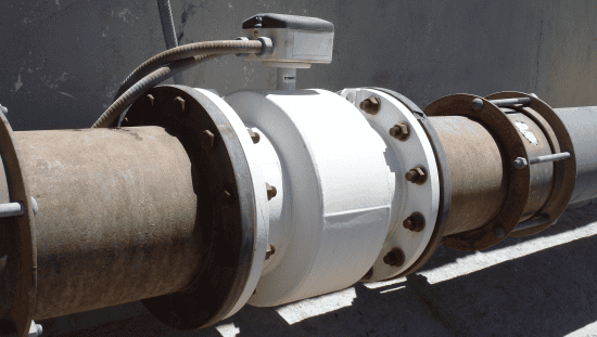 A rusty magnetic inductive flowmeter (magmeter) installed in accordance with AWWA C751-2019.