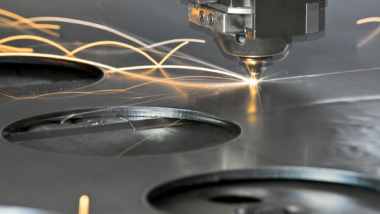 CNC machining slicing through metal with a laser with standard tooling parts.