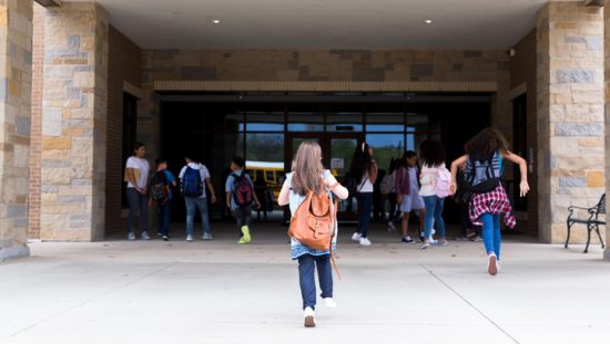 Kids running into school building that has been tested for radon through ANSI/AARST MALB.