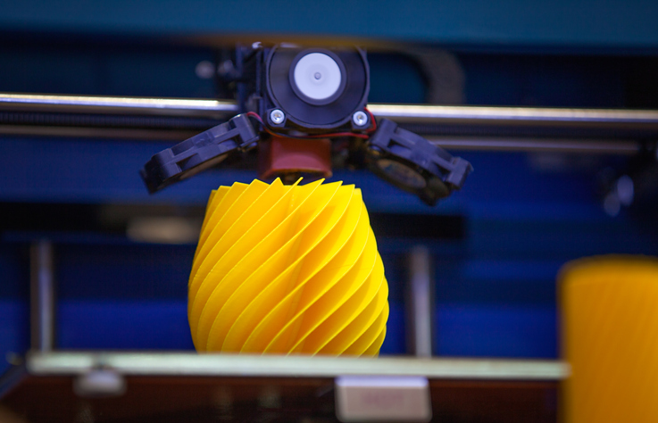 Additive Manufacturing A yellow spiral object being 3D printed according to ISO/ASTM 52900 terminology.