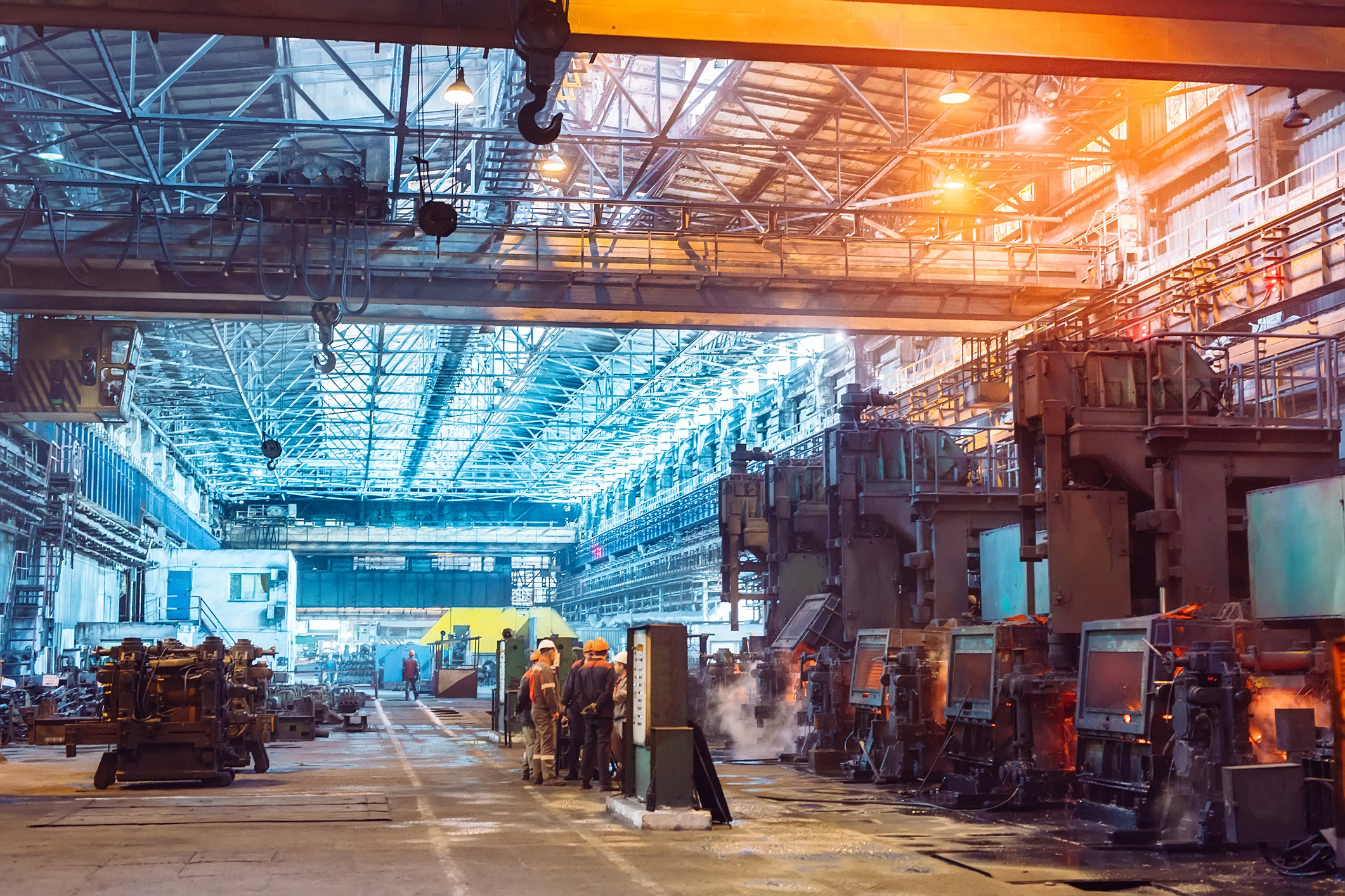 Workers in a steel plant that are kept safe due to ANSI/ASSP Z590.3-2021 prevention through design guidelines.